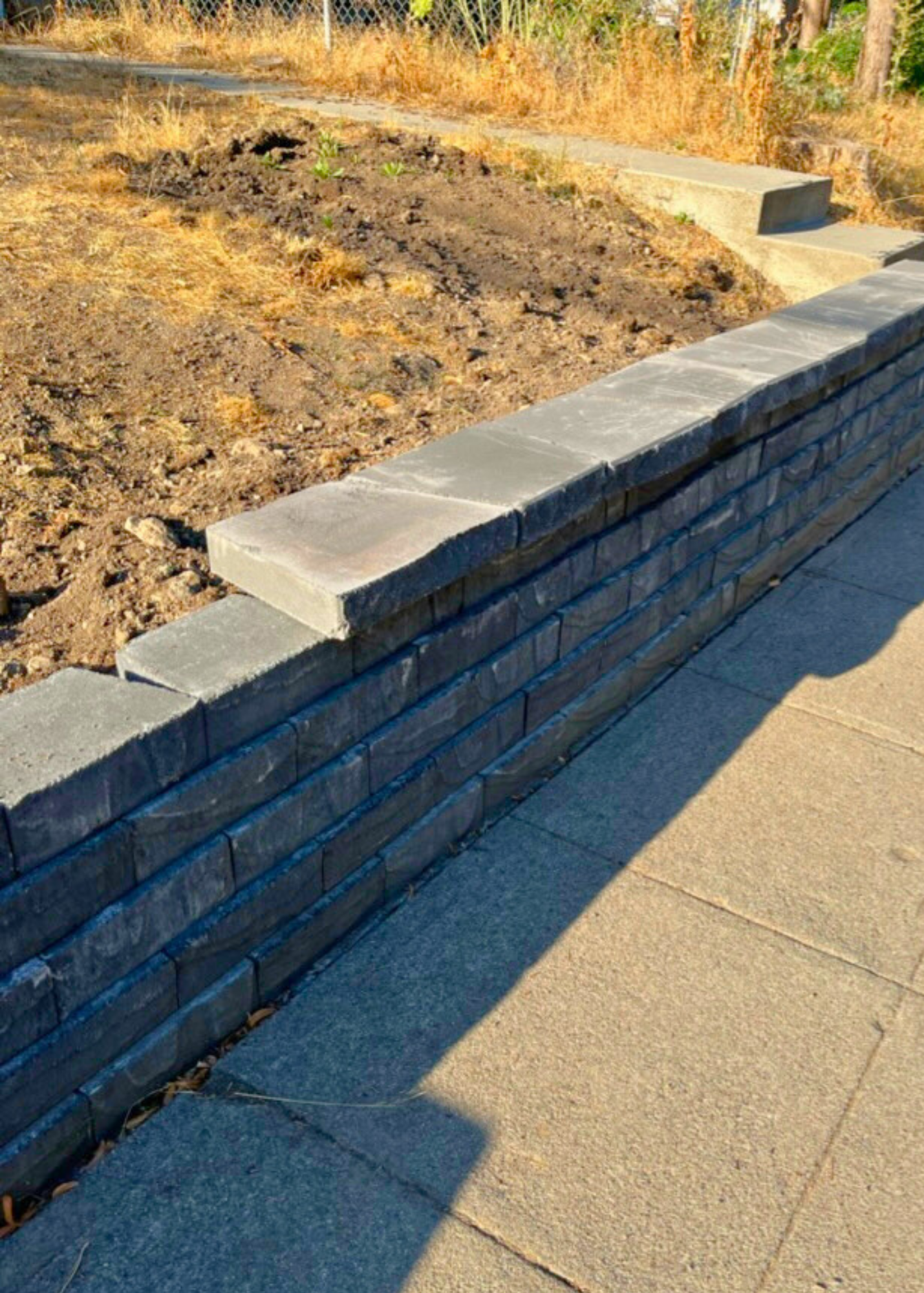 A half built retaining wall in front of house.